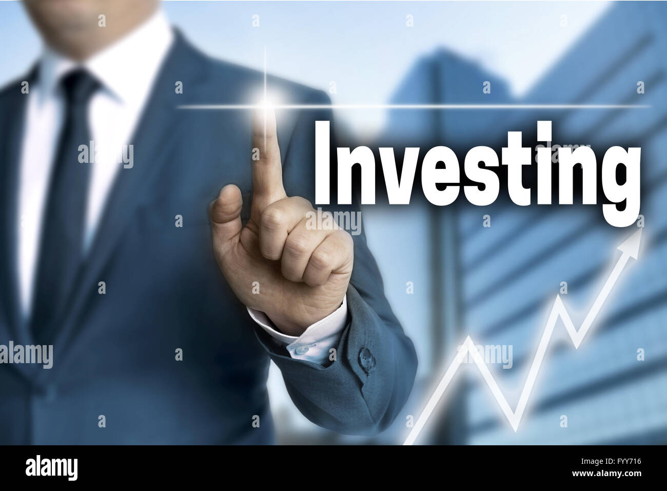 investing touchscreen is operated by businessman. Stock Photo