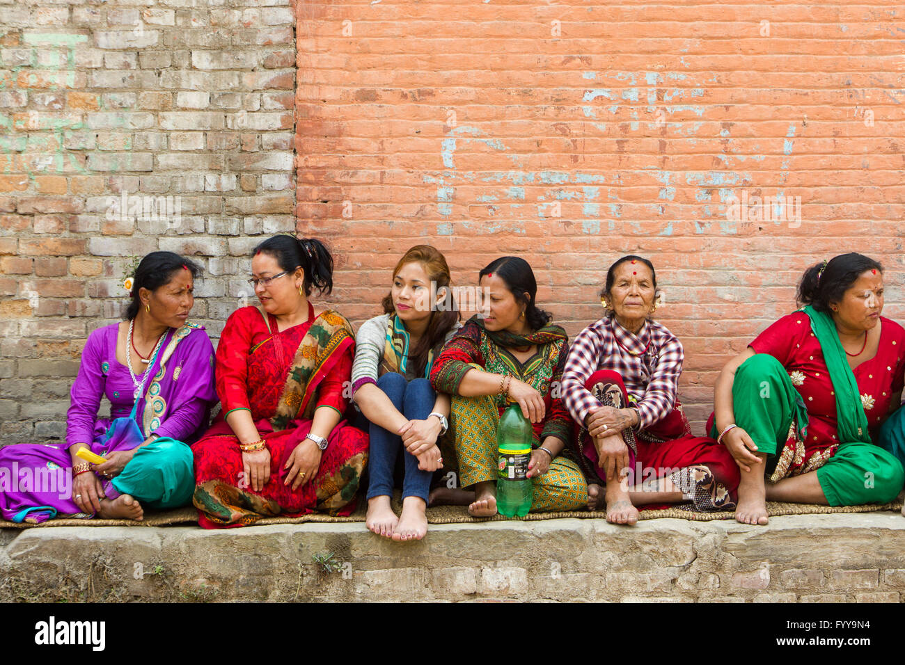 Newar women sit and await Bisket Jatra festivities. Stock Photo
