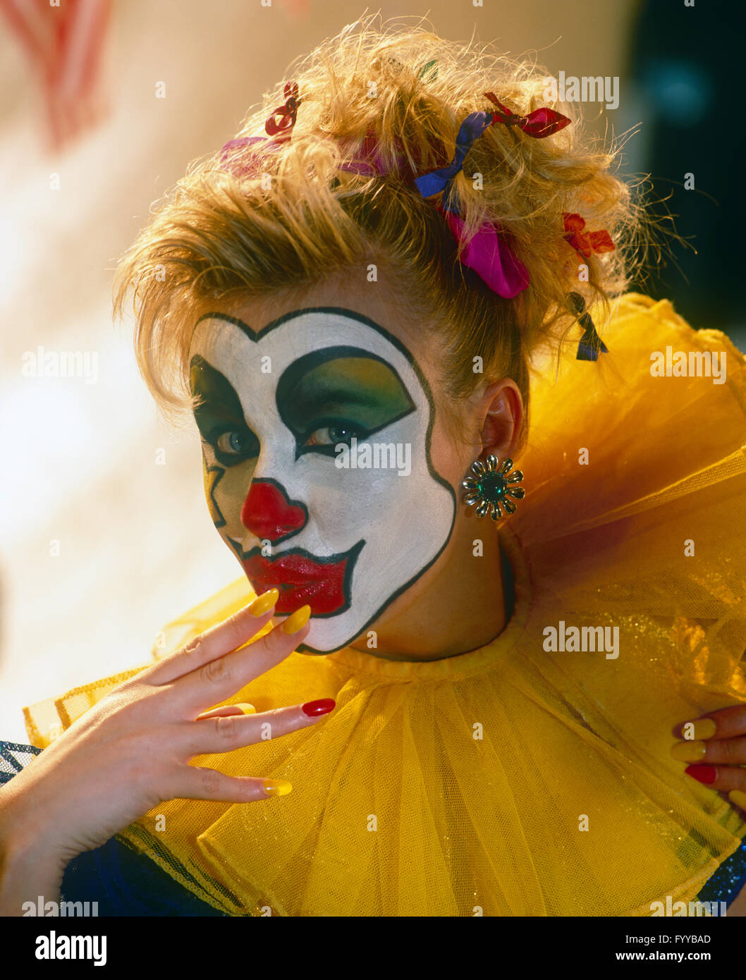 Girl clown with face paint, inside. Stock Photo