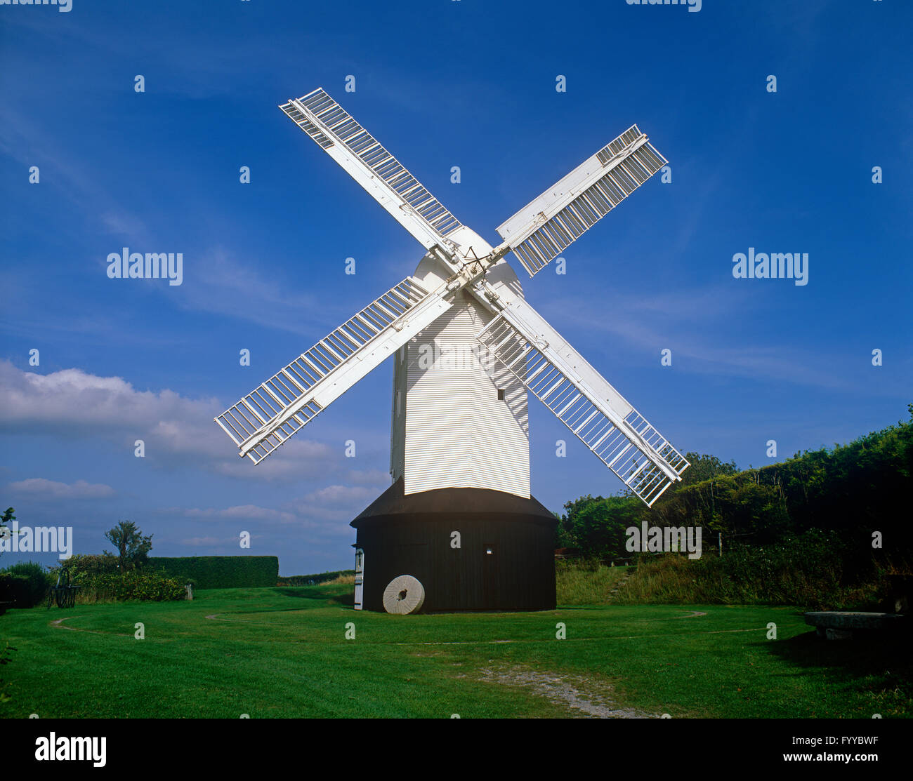 A white windmill on a hill, outside. Stock Photo