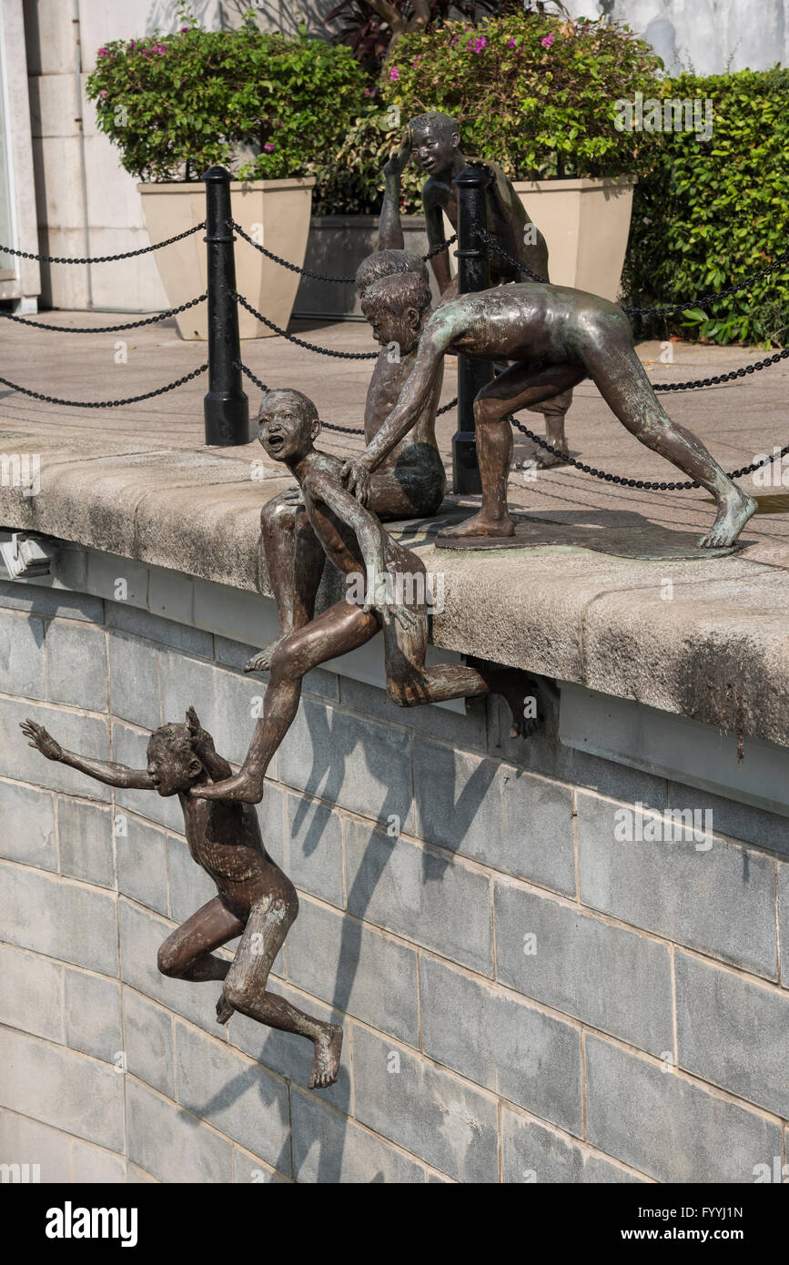 First Generation. A Sculpture of Five Boys Leaping into the Singapore River near Cavenagh Bridge in Singapore Stock Photo