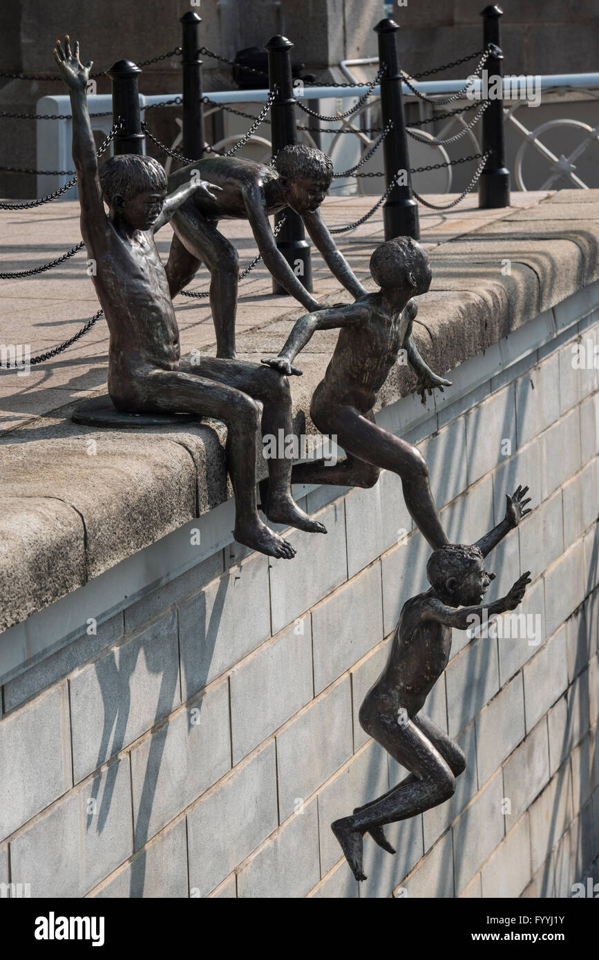First Generation. A Sculpture of Five Boys Leaping into the Singapore River near Cavenagh Bridge in Singapore Stock Photo