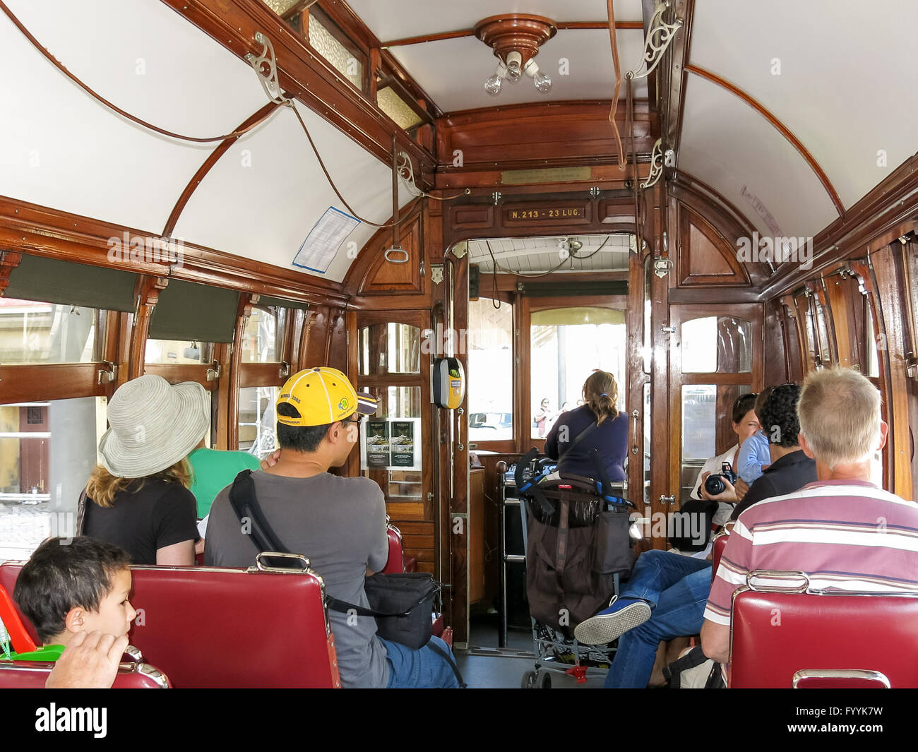 Tourists inside vintage tramcar of heritage tram line in Porto, Portugal Stock Photo