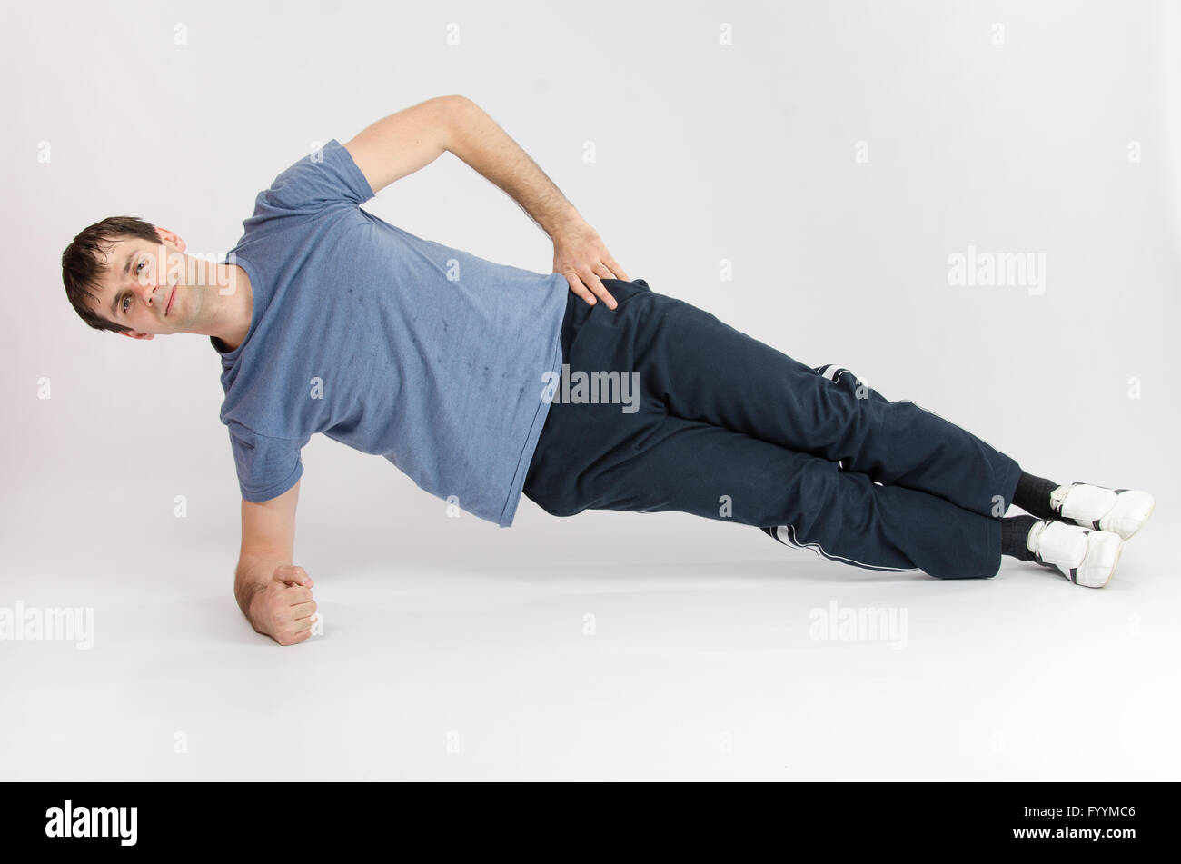 Athlete holding body leaning on the right arm Stock Photo