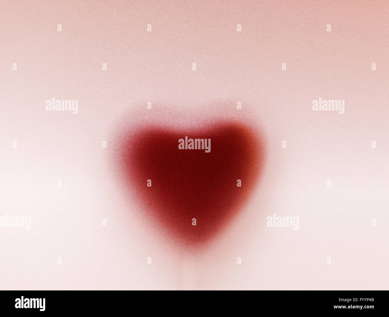 Heart shape behind milky frosted glass. Love Stock Photo