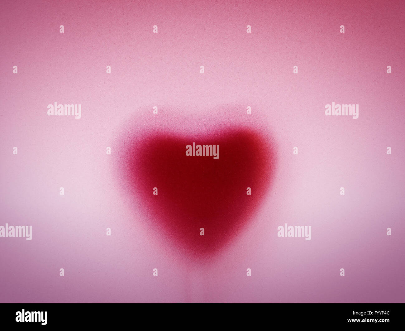 Heart shape behind milky frosted glass. Love Stock Photo