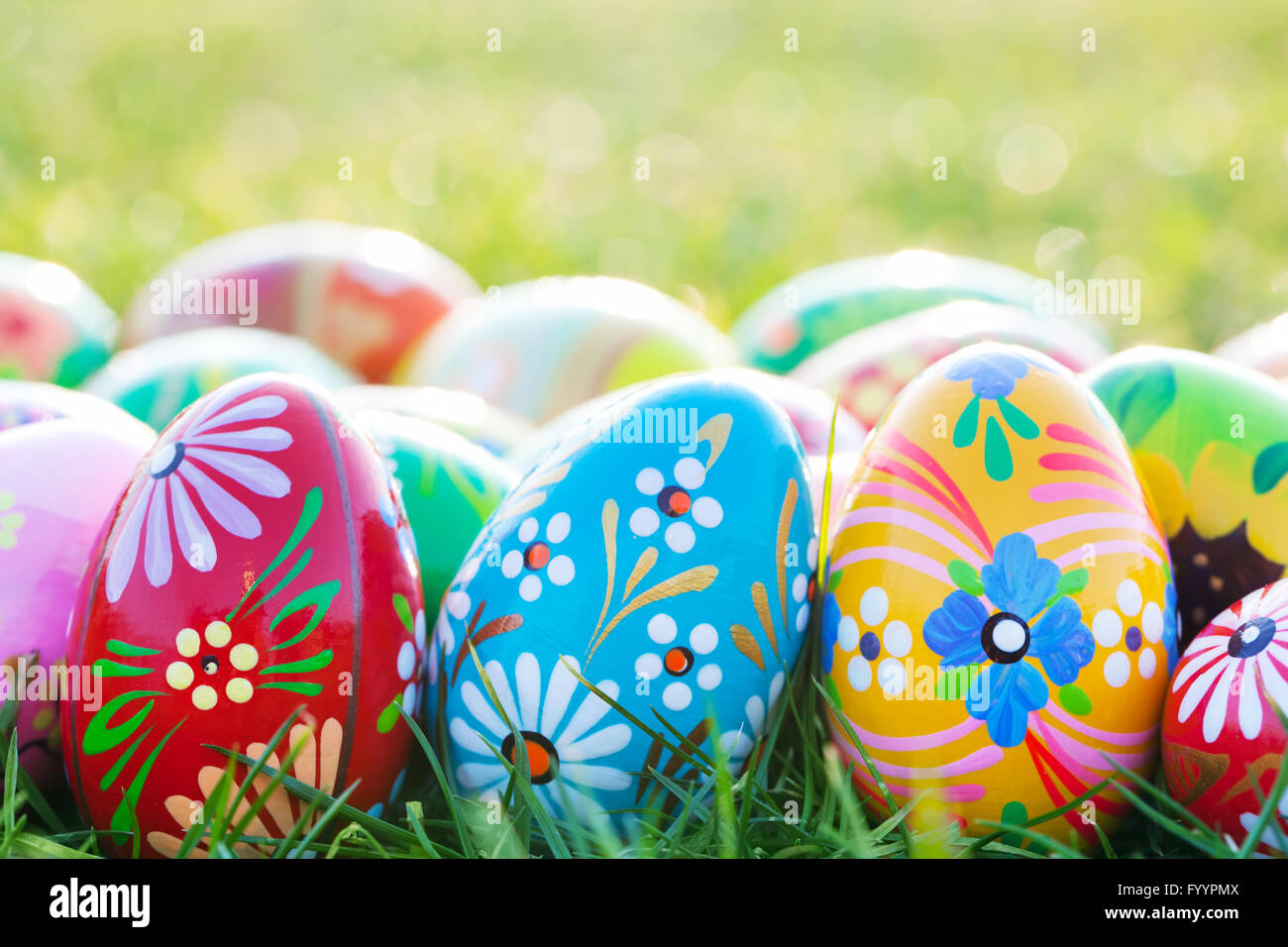 Hand-painted Easter eggs on grass. Floral Stock Photo