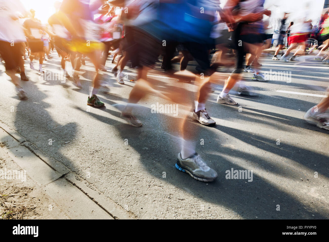 Marathon runners in motion. Running Stock Photo