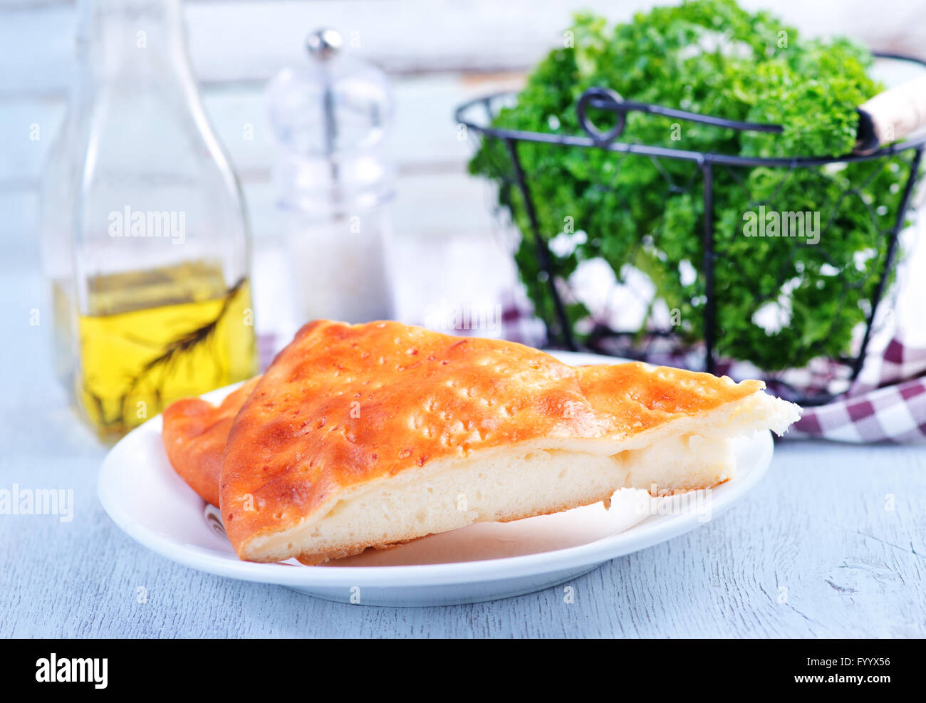 pie with cheese on plate and on a table Stock Photo