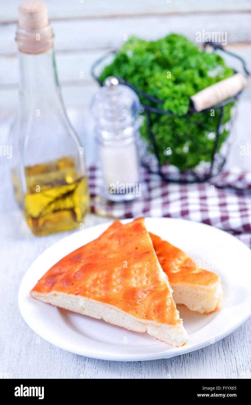 pie with cheese on plate and on a table Stock Photo