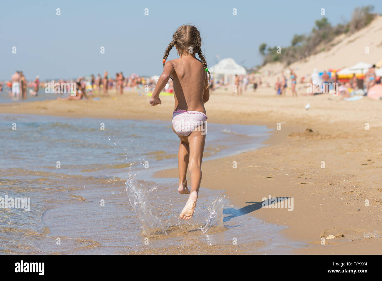 Six year old girl running on the beach Stock Photo - Alamy