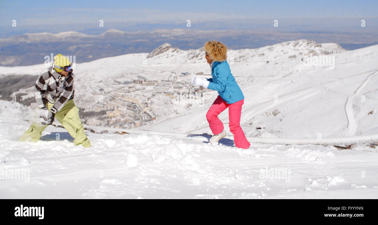 Young couple having fun playing in the snow Stock Photo - Alamy