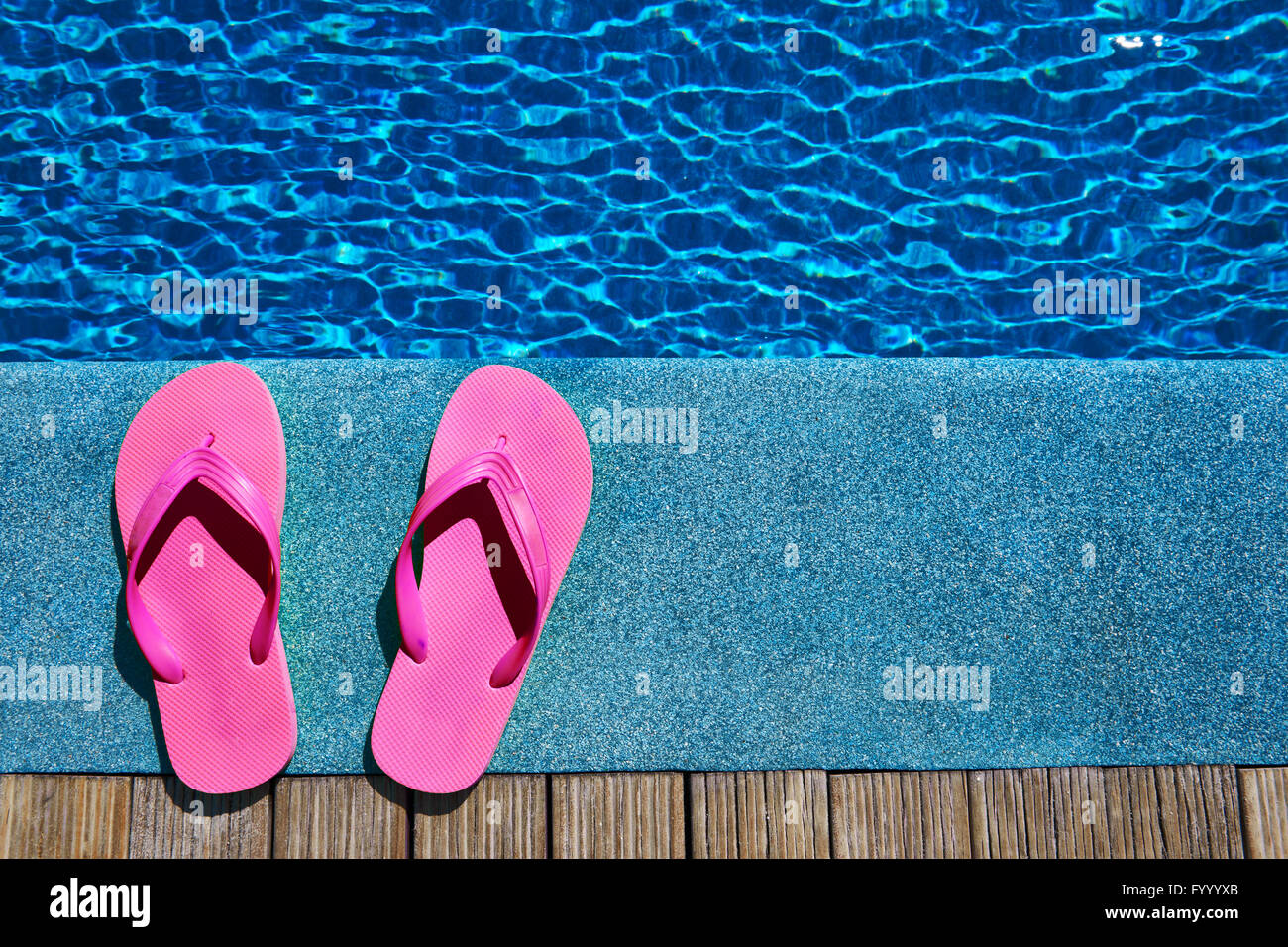 Slippers by a swimming pool Stock Photo - Alamy