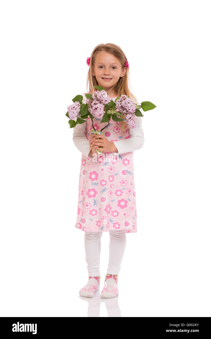 Smiling little girl with lilac flowers Stock Photo - Alamy