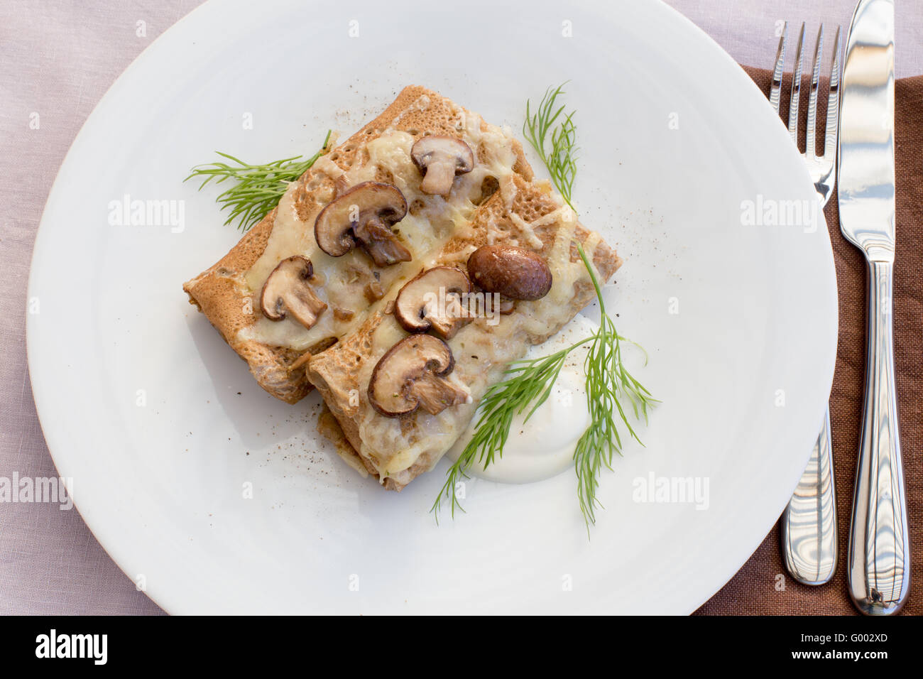 Salty pancakes with mushrooms Stock Photo