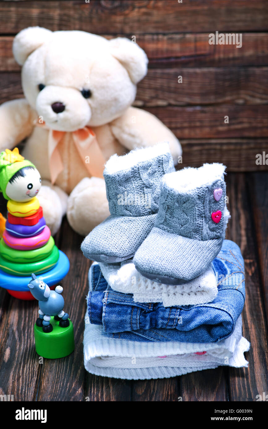 baby clothes and shoes on the wooden table Stock Photo Alamy