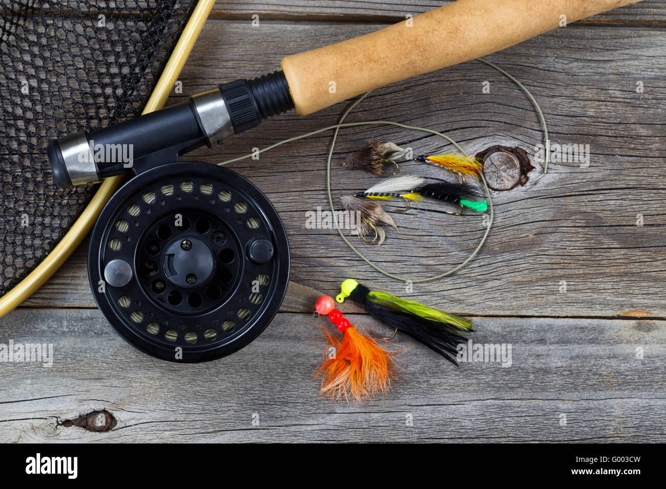 Fishing Fly reel with accessories on wood Stock Photo - Alamy