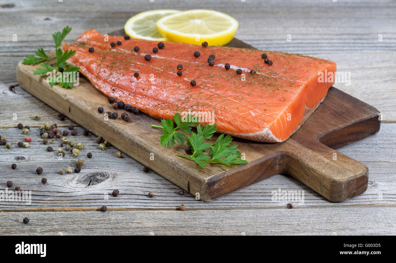 Seasoned Salmon Fillet on rustic wood Stock Photo