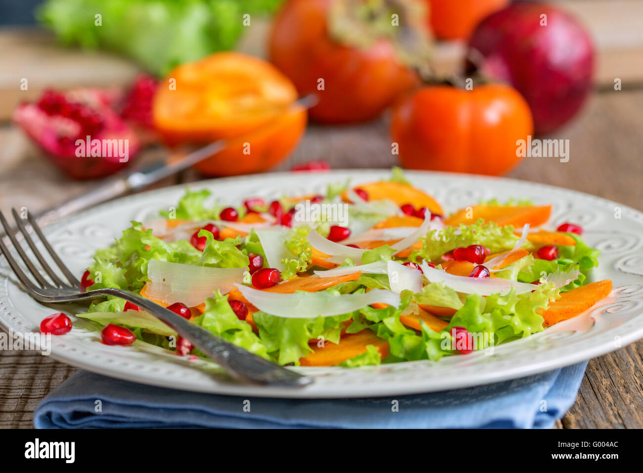 Delicious salad with persimmon. Healthy food. Stock Photo