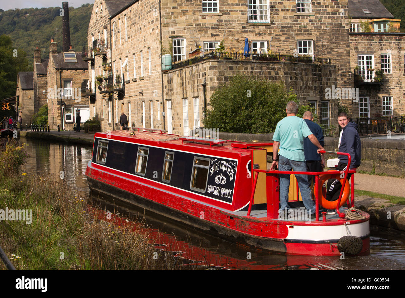 UK, England, Yorkshire, Calderdale, Hebden Bridge, Rochdale Canal Shire Cruisers hire narrowboat passing canalside apartments Stock Photo