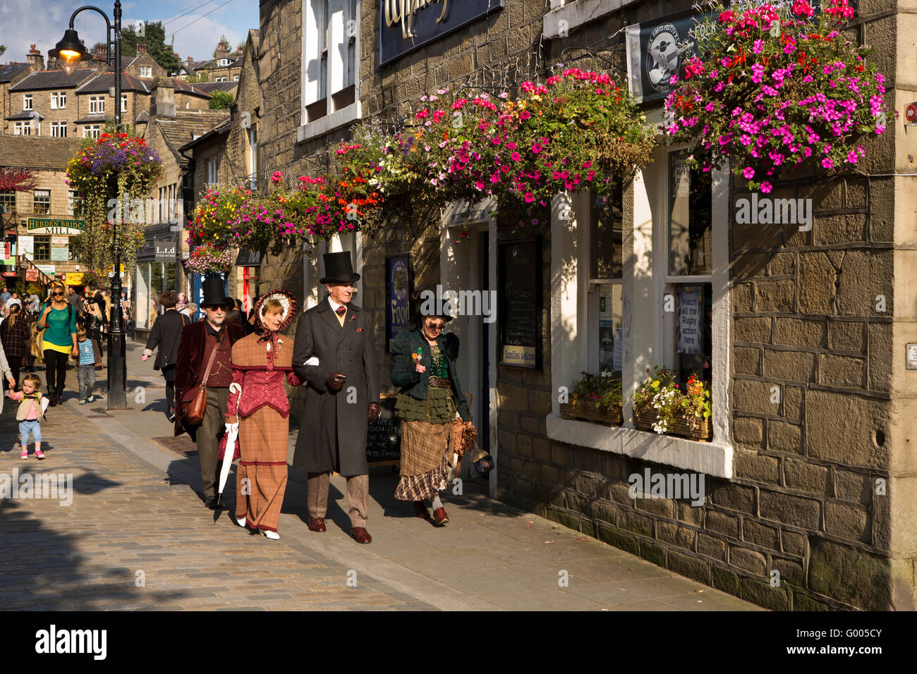 UK, England, Yorkshire, Calderdale, Hebden Bridge, Bridge Gate, Steampunk enthusiasts walking past White Swan pub Stock Photo