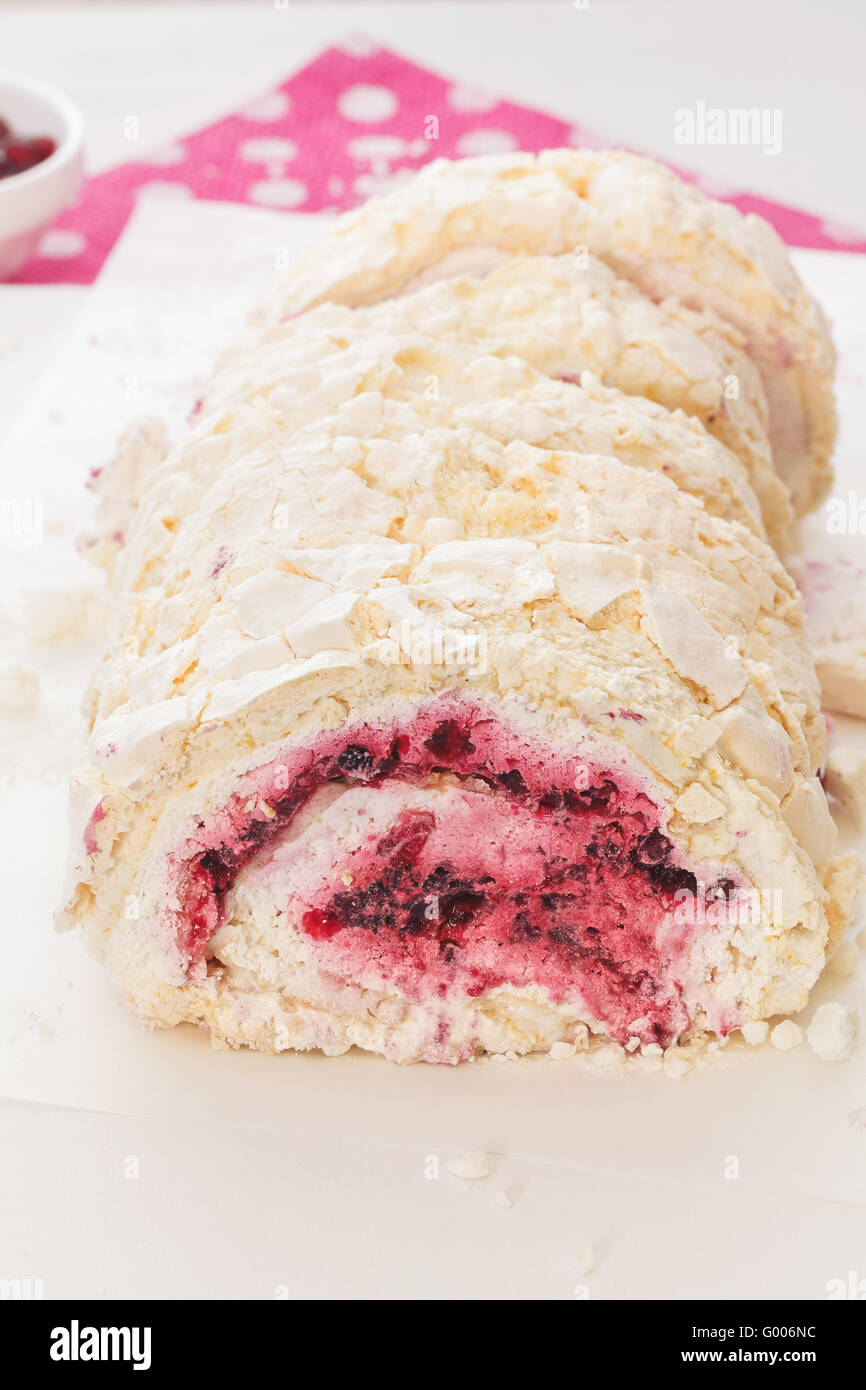 Meringue roulade. Meringue roll with cream and fresh red berry fruits
