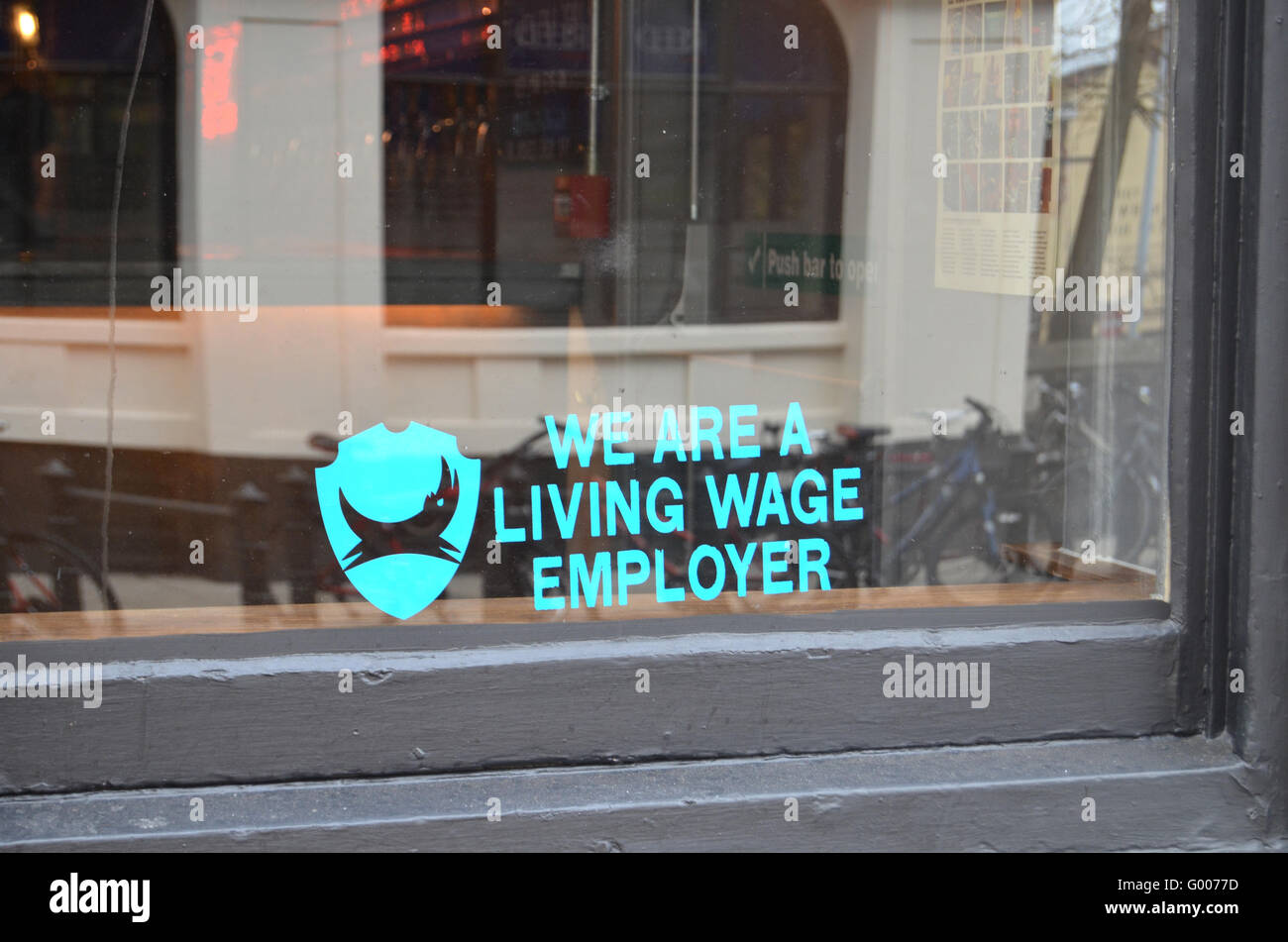 Living Wage Employer sign in window of Brewdog bar, Norwich April 2016 Stock Photo