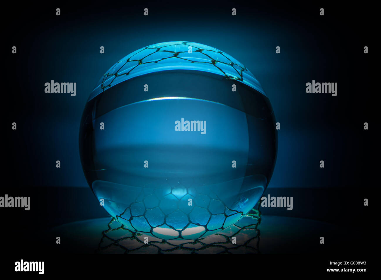 Glass ball in a net Stock Photo Alamy