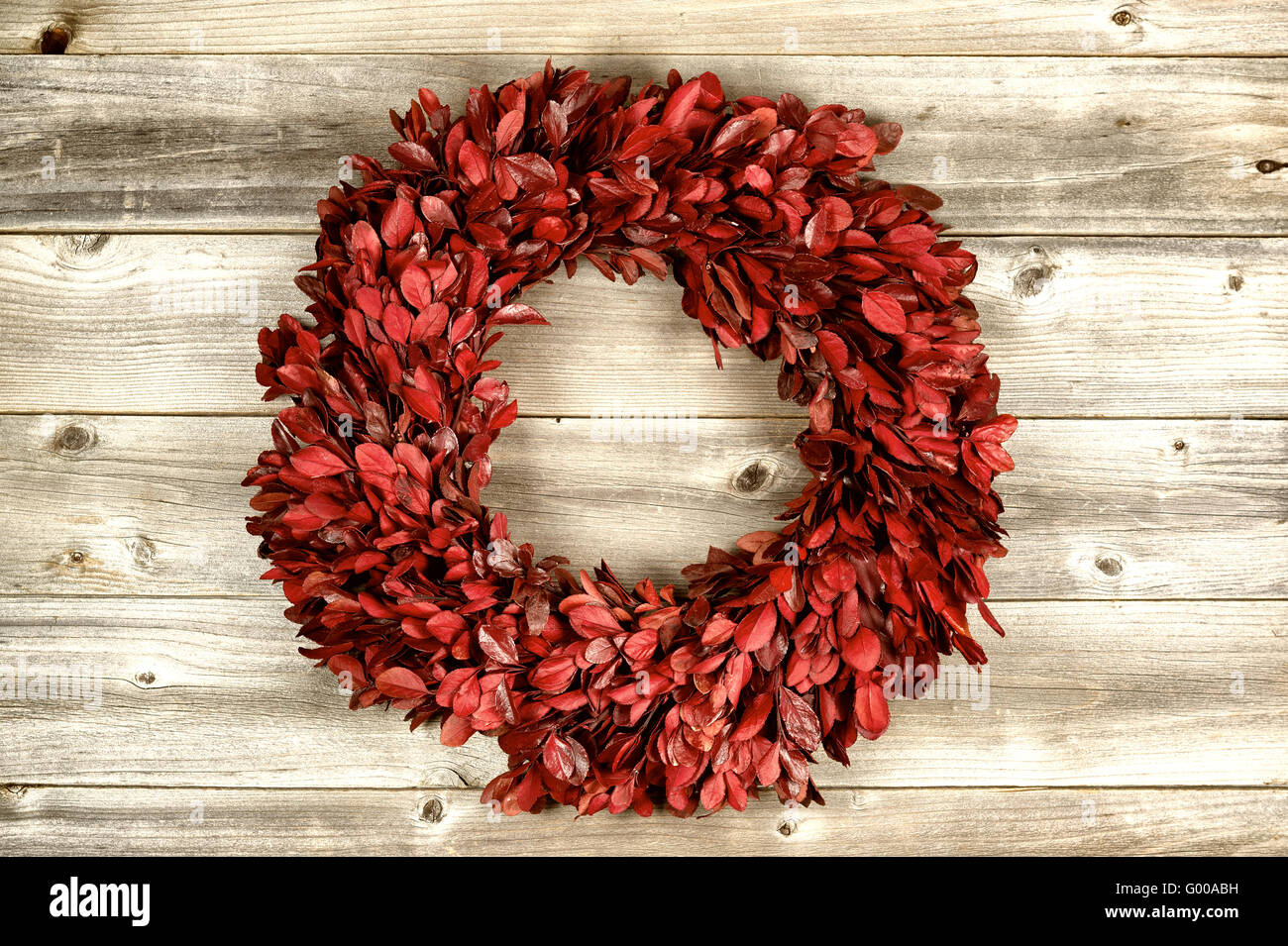 Red Wreath on vintage wood for the holidays Stock Photo