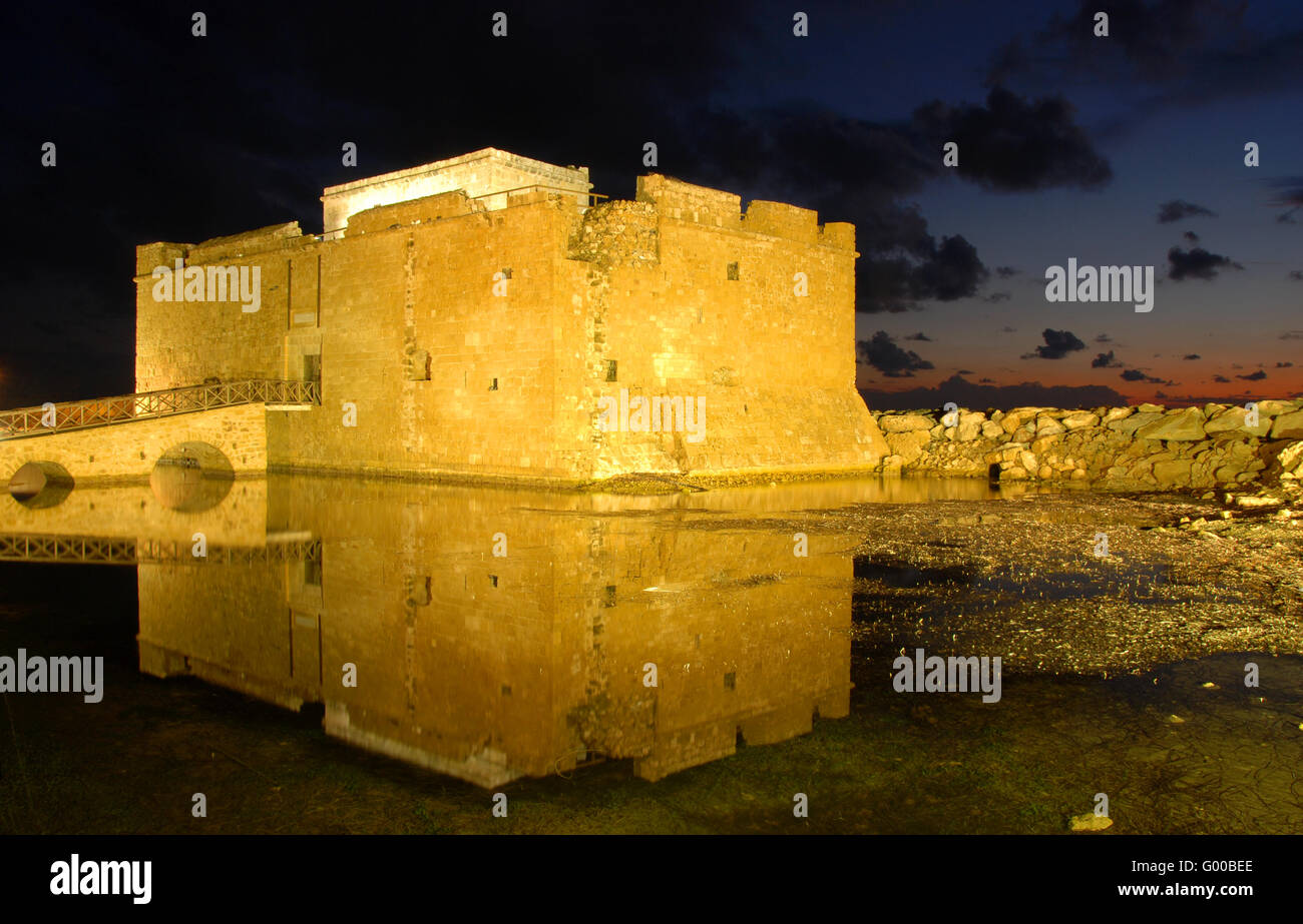 Famous Paphos medieval Castle close to the fishing harbor of Paphos city  reflected on water. Stock Photo