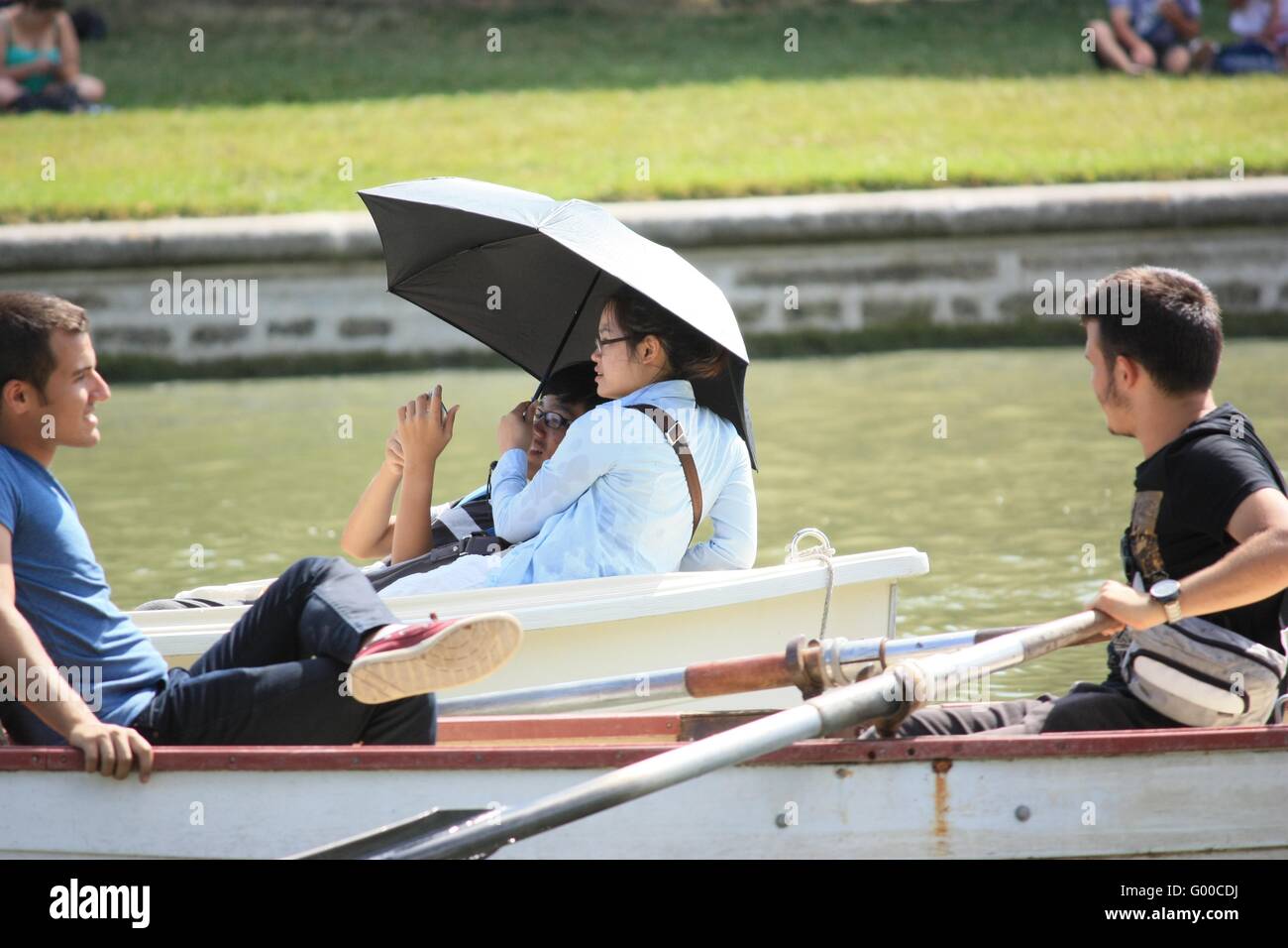 Unidentified tourists from all over the world on a boat in Versailles park Stock Photo