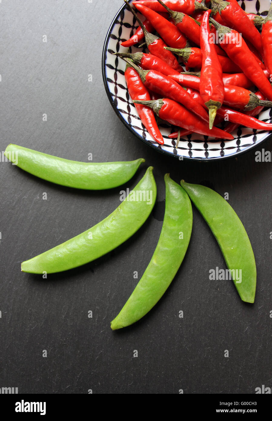 Chilis and snow peas Stock Photo