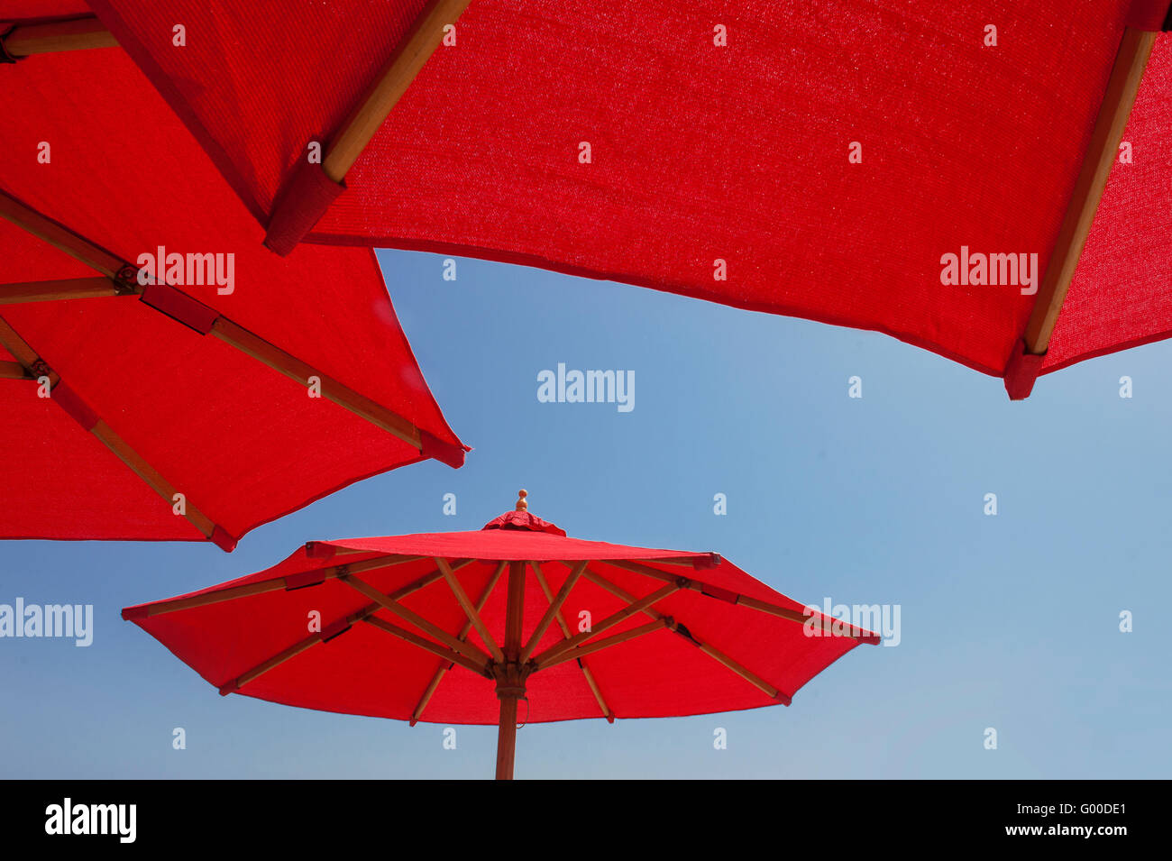 red umbrellas on blue sky background Stock Photo