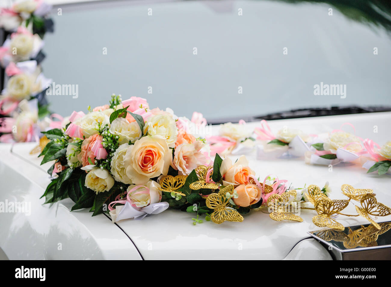 Wedding car decoration of flowers with roses and butterflies Stock