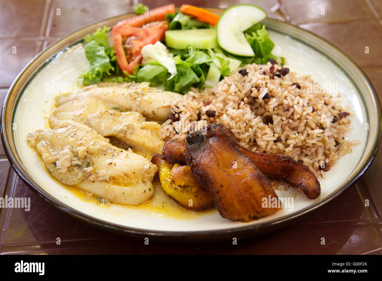 Cooked plantain served with coconut rice and fresh fish in Cahuita, Costa Rica. Stock Photo
