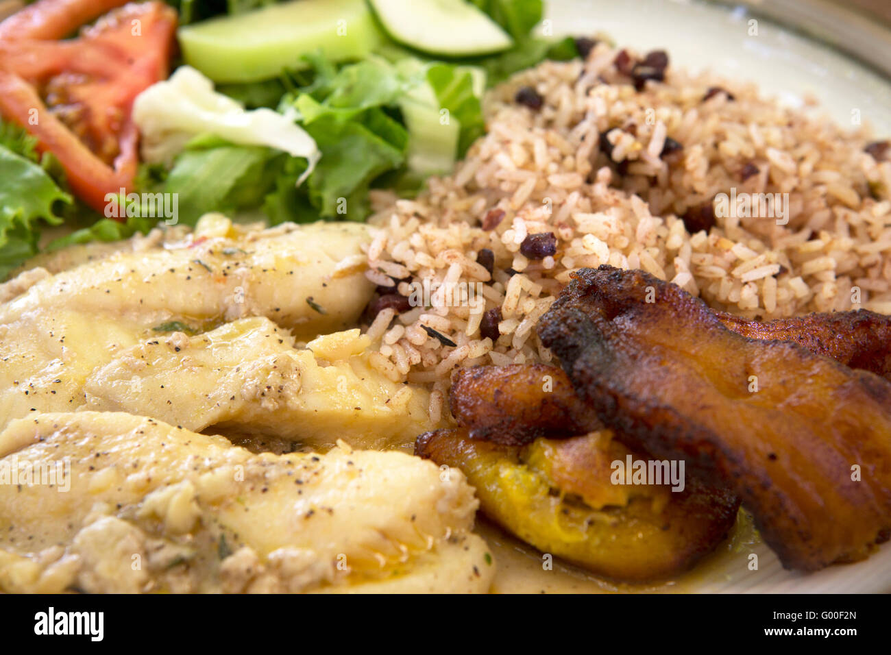 Cooked plantain served with coconut rice and fresh fish in Cahuita, Costa Rica. Stock Photo