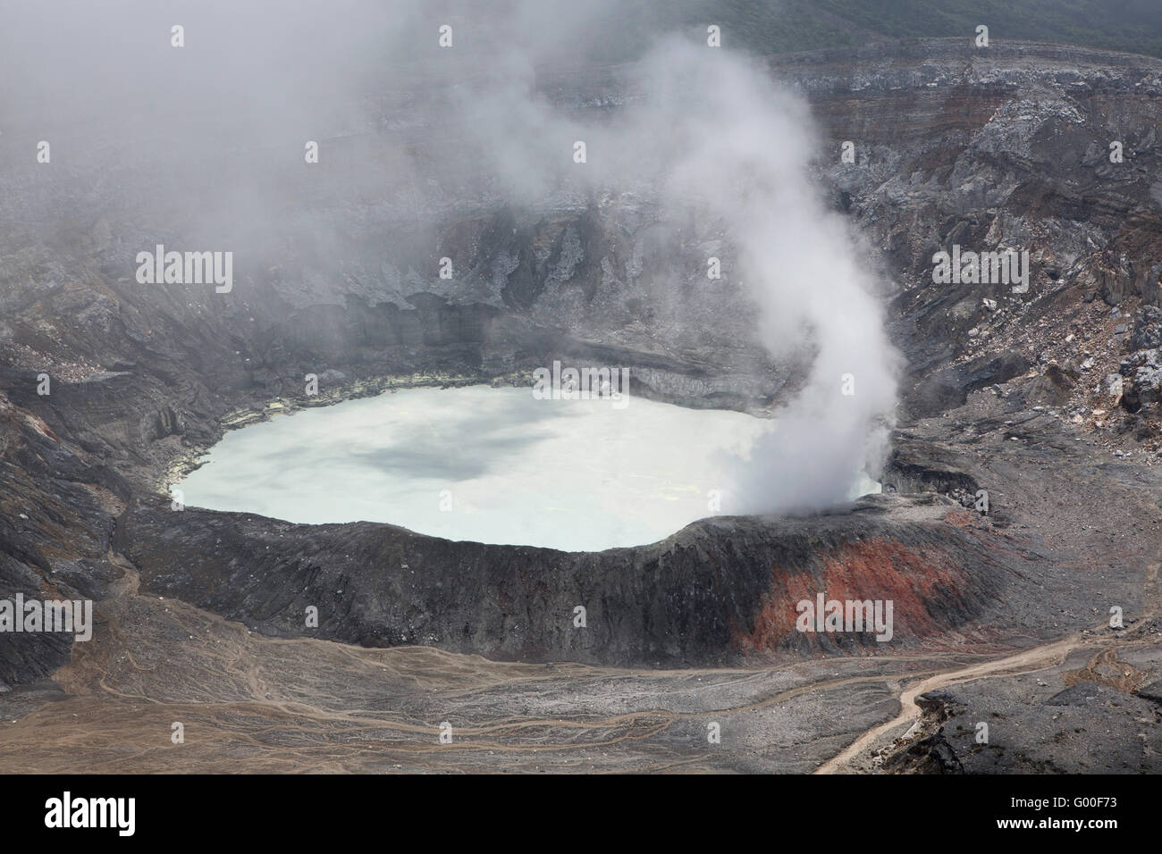 Steam rises from the crater of Poas Volcano in Parque Nacional Volcan Poas (Poas Volcano National Park) in Costa Rica. Stock Photo