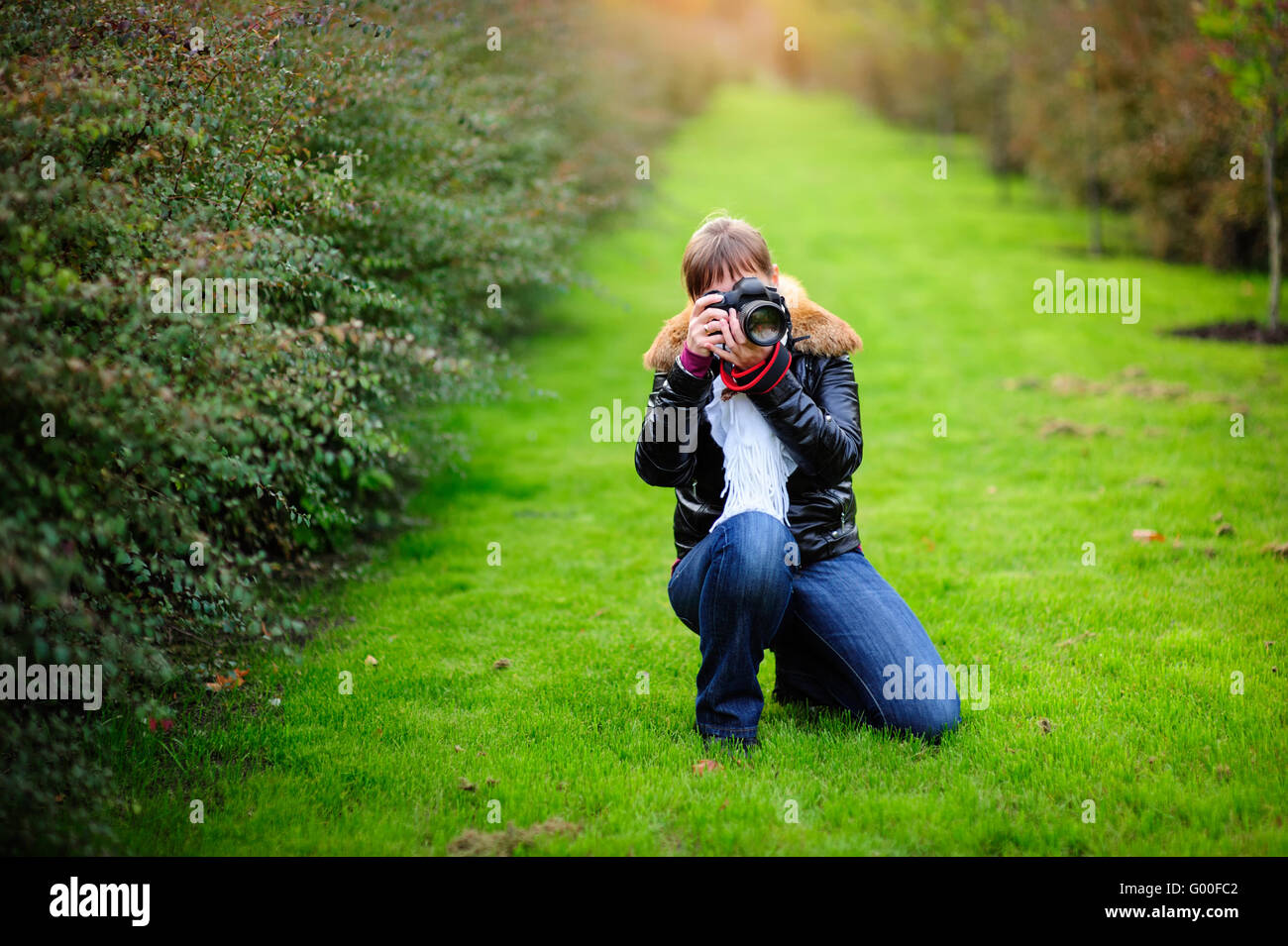 Photographer taking pictures outdoors Stock Photo