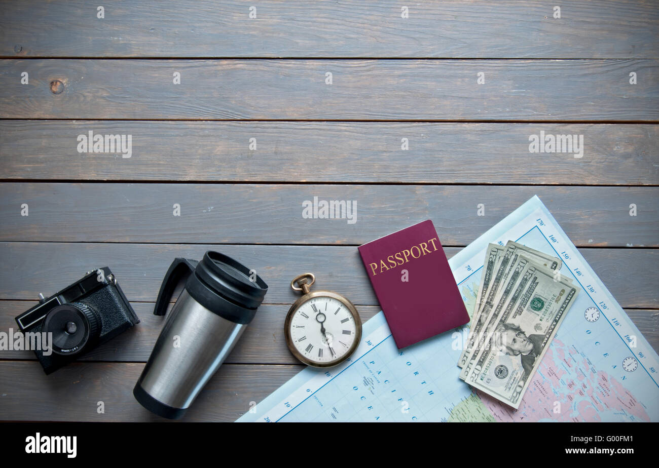 Travel objects on a wooden background with passport, camera and map Stock Photo