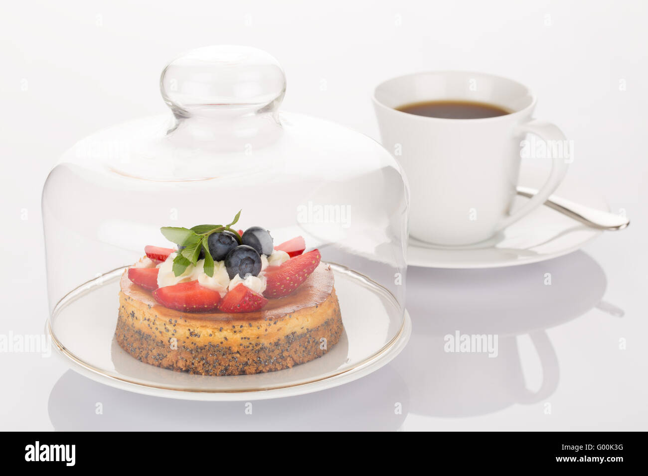 Cheesecake, glass bell and cup of coffee Stock Photo
