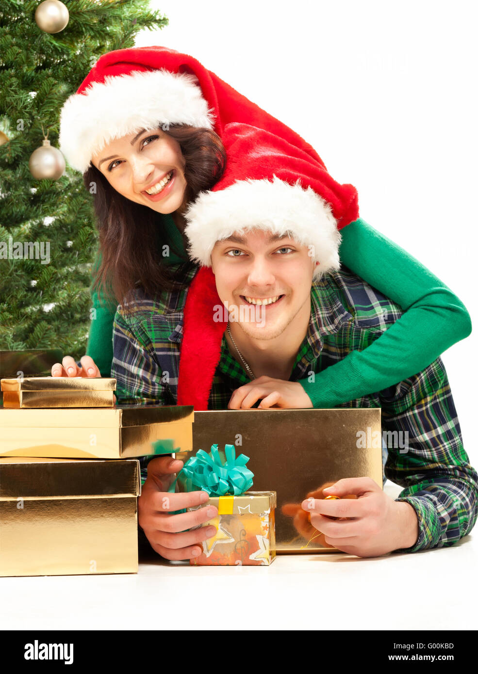 Young happy couple near a Christmas tree. Stock Photo