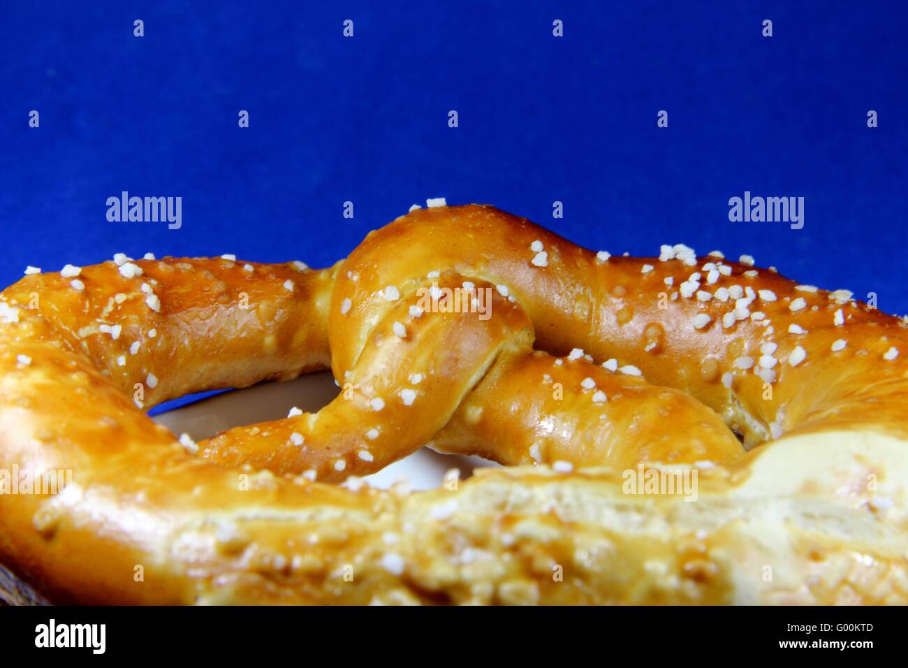 Pretzel blue background Stock Photo Alamy