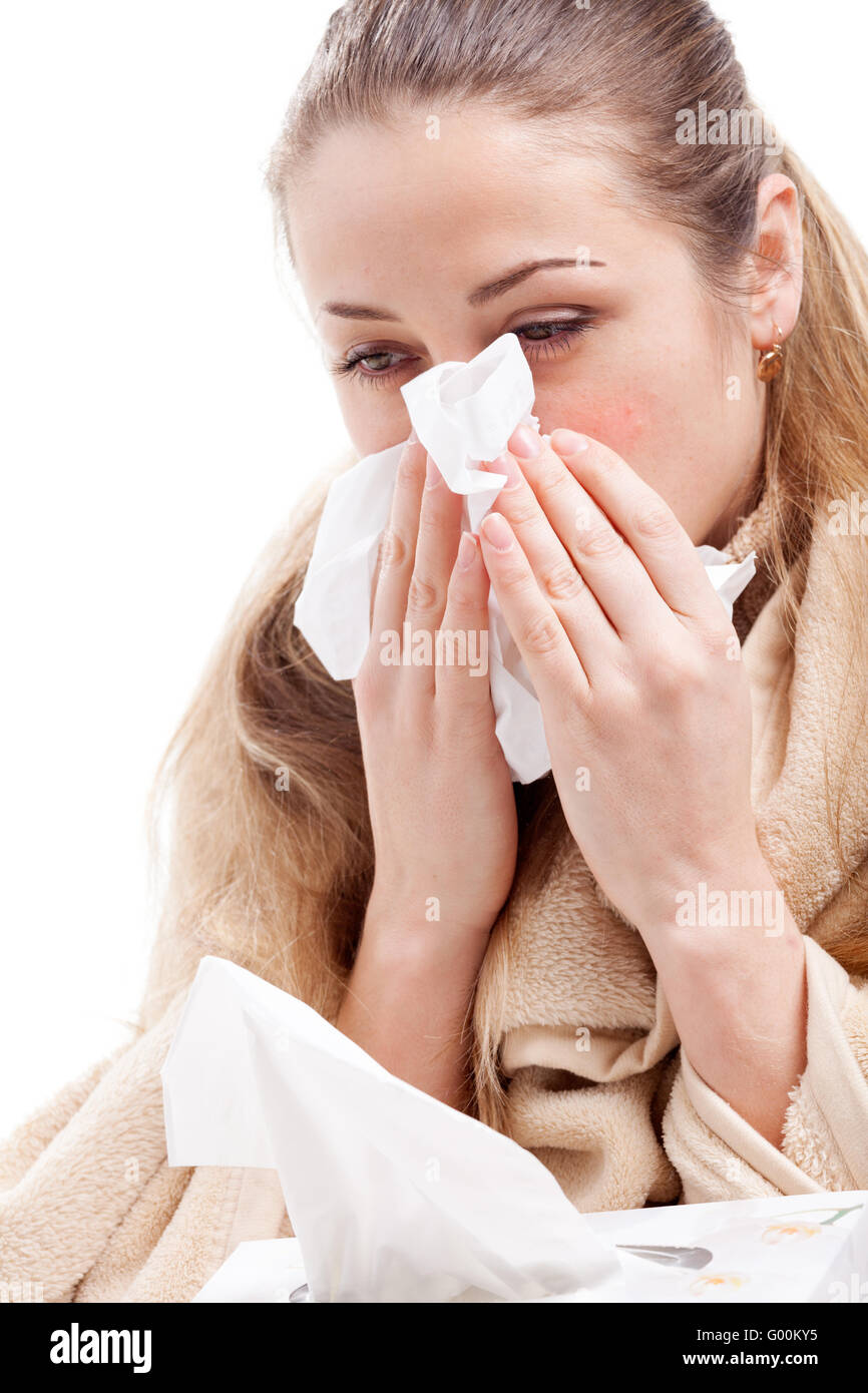 Sick woman blowing her nose Stock Photo