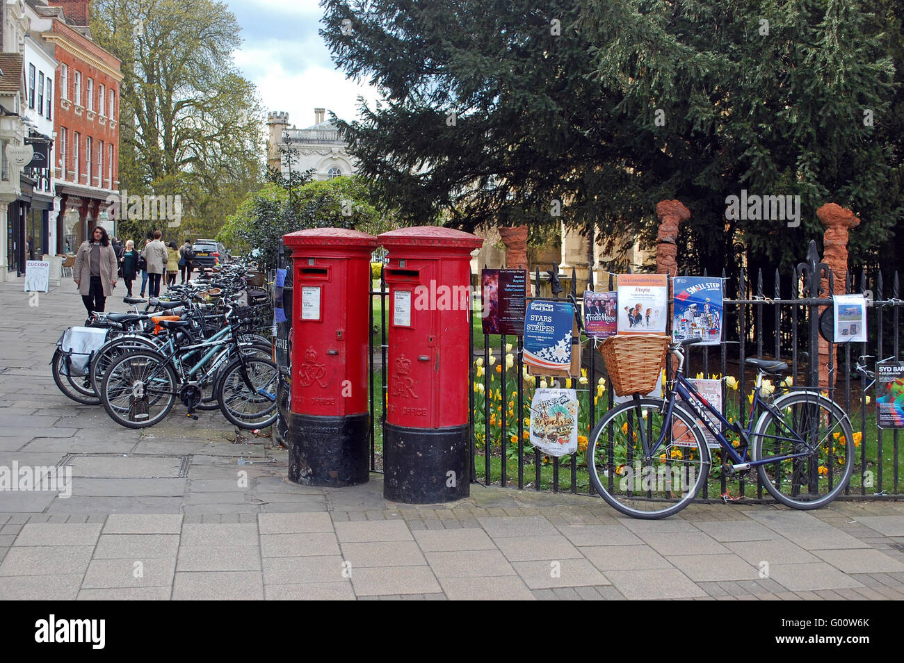Two bright red traditional english postboxes, surrounded by bikes, in Cambridge Stock Photo