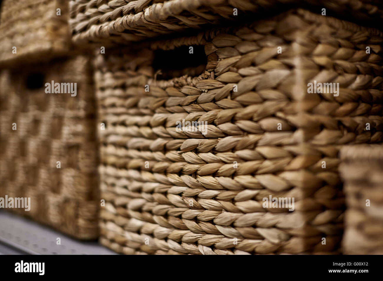 Stacks of natural fiber storage baskets in a rectangular shape with shallow depth of field Stock