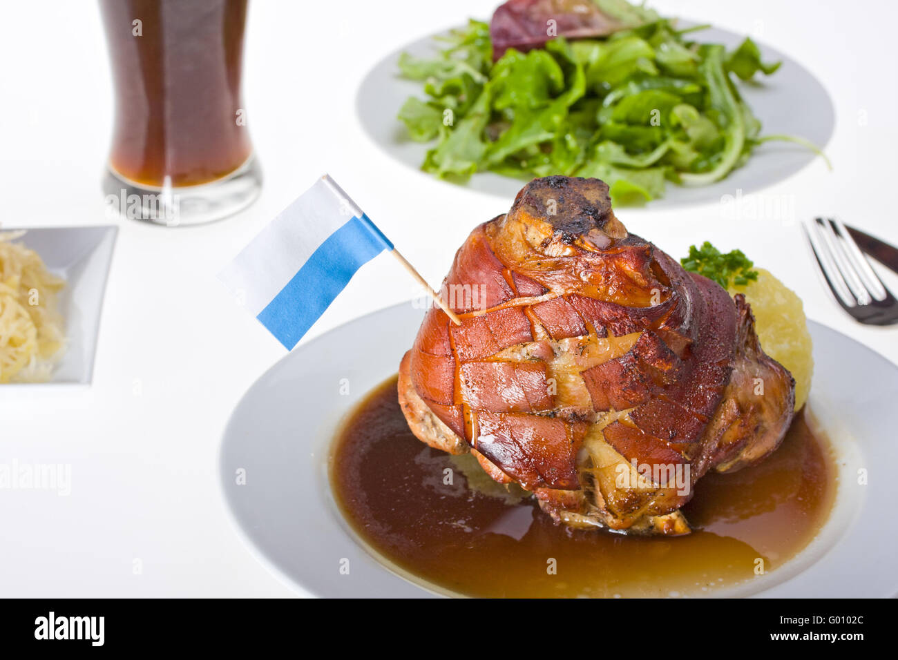 bavarian knuckle of pork with potato dumpling Stock Photo Alamy
