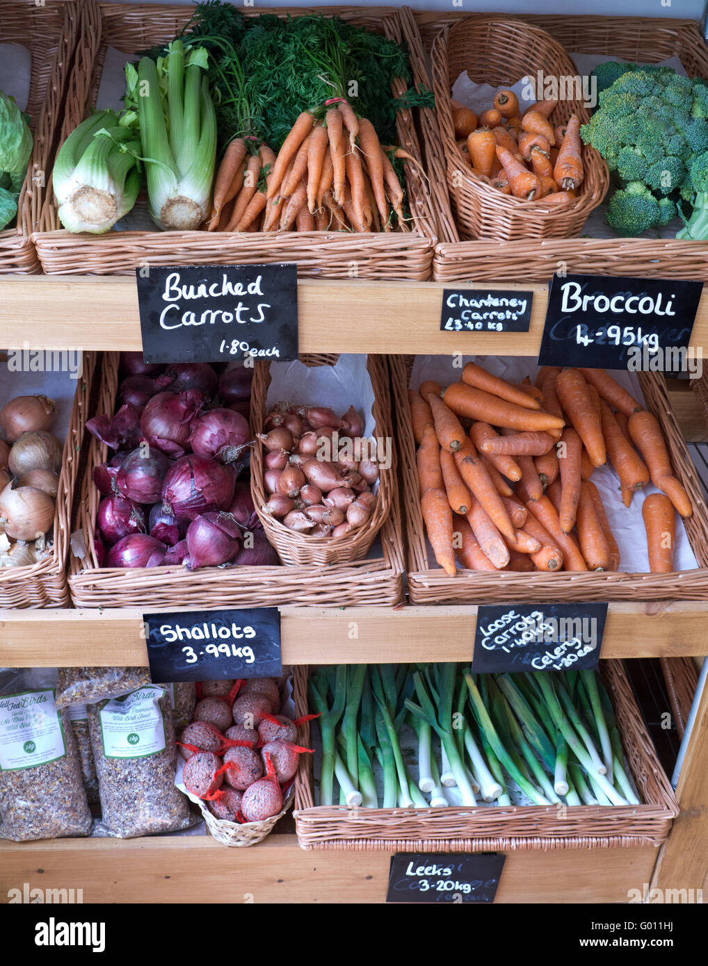Vegetables local UK produce blackboard display in UK British greengrocers farm shop interior with fresh fruit vegetables Stow on the Wold Cotswolds UK Stock Photo