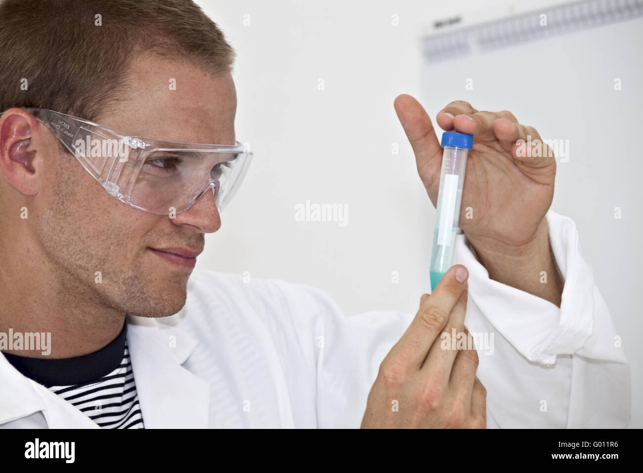 young lab technician looking a at medical sample Stock Photo