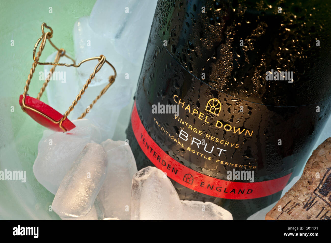 Award winning English sparkling wine 'Chapel Down Brut'  bottle on ice in wine cooler with cork and retaining cap Stock Photo