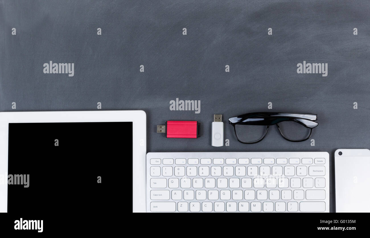 Wiped down blackboard with mobile devices Stock Photo Alamy